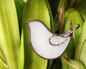 Dove plant stake of minimalist design, in wispy white art glass with twisted wire wing detail, on a brass rod placed in a potted plant